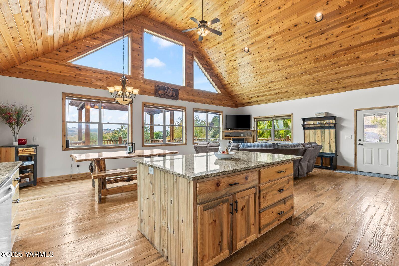 233 Tibbling Road Selah, WA 98942 - Photo 11 of 51 a view of a kitchen with kitchen island granite countertop a large window a sink and counter space