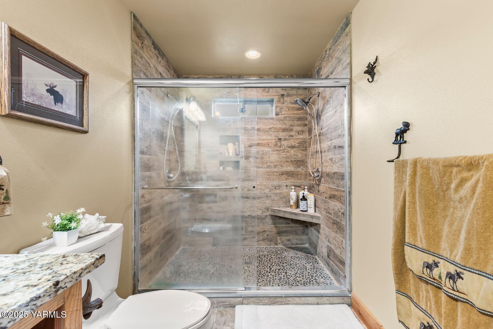 233 Tibbling Road Selah, WA 98942 - Photo 15 of 51 a bathroom with a granite countertop sink mirror vanity and toilet