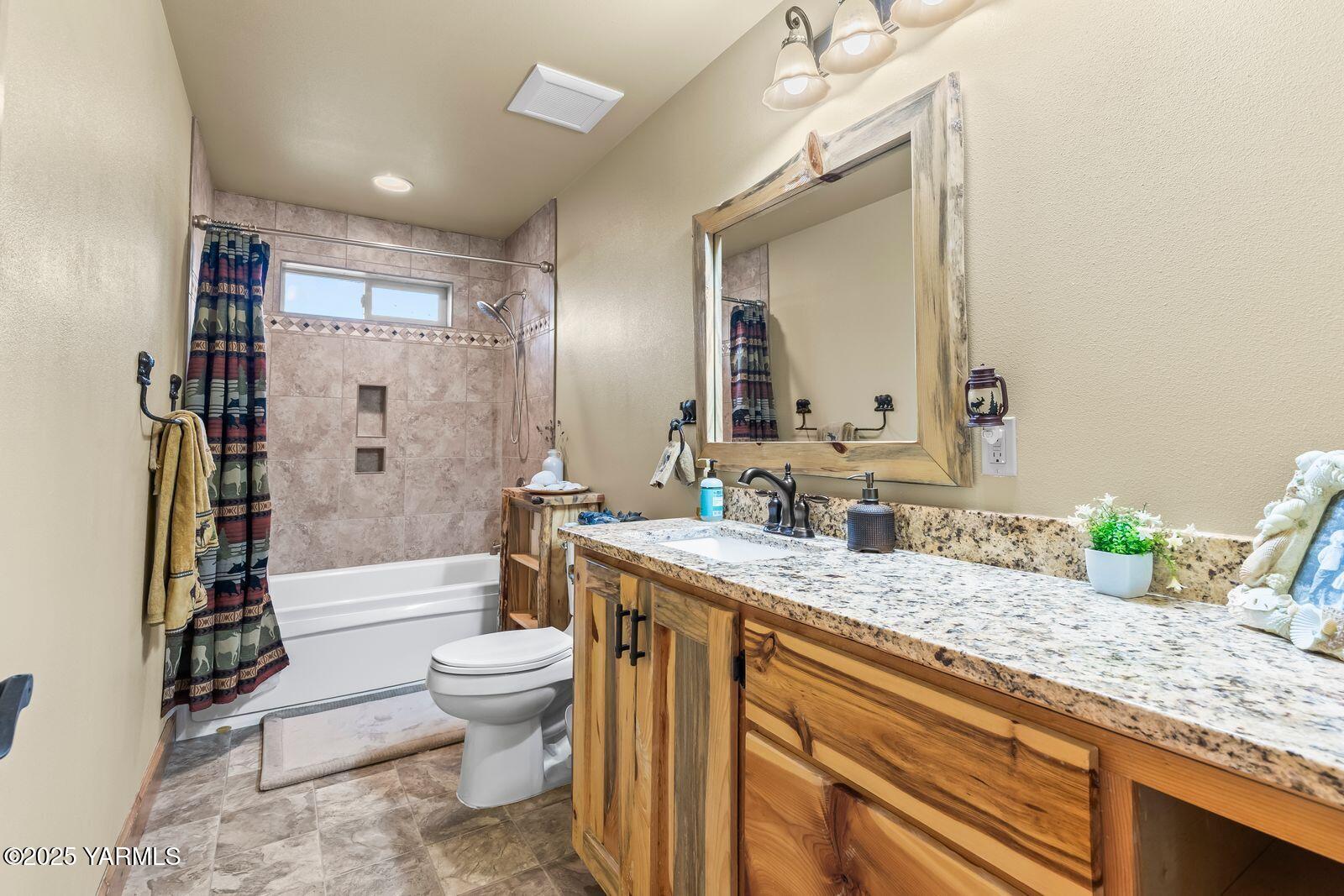 233 Tibbling Road Selah, WA 98942 - Photo 18 of 51 a bathroom with a granite countertop sink mirror vanity and toilet