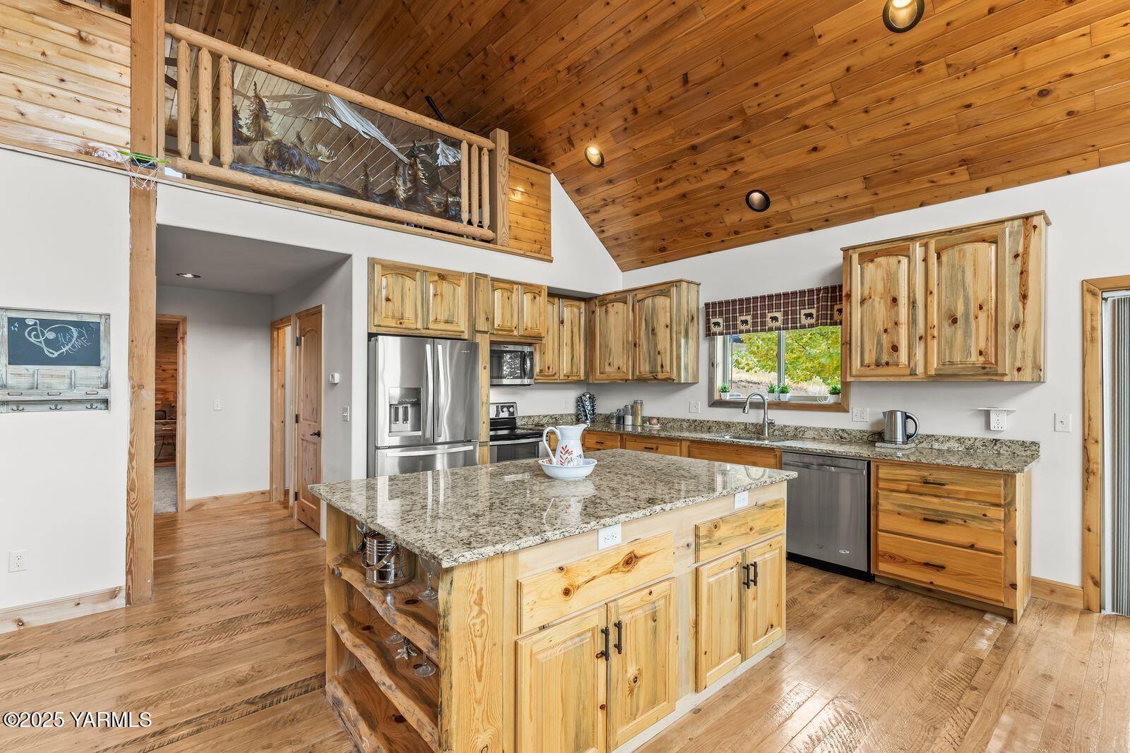 233 Tibbling Road Selah, WA 98942 - Photo 9 of 51 a kitchen with stainless steel appliances granite countertop a sink a stove and cabinets