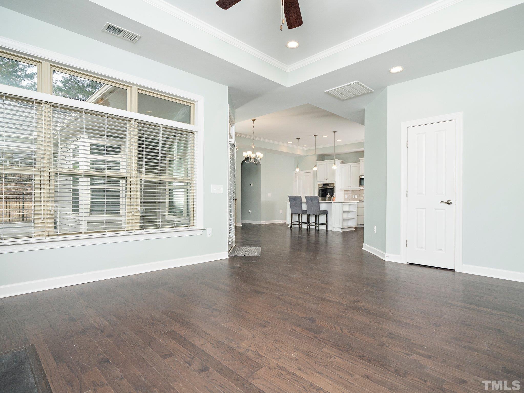 1209 Provision Place Wake Forest, NC 27587 - Photo 6 of 22 a view of empty room with wooden floor and floor to ceiling window