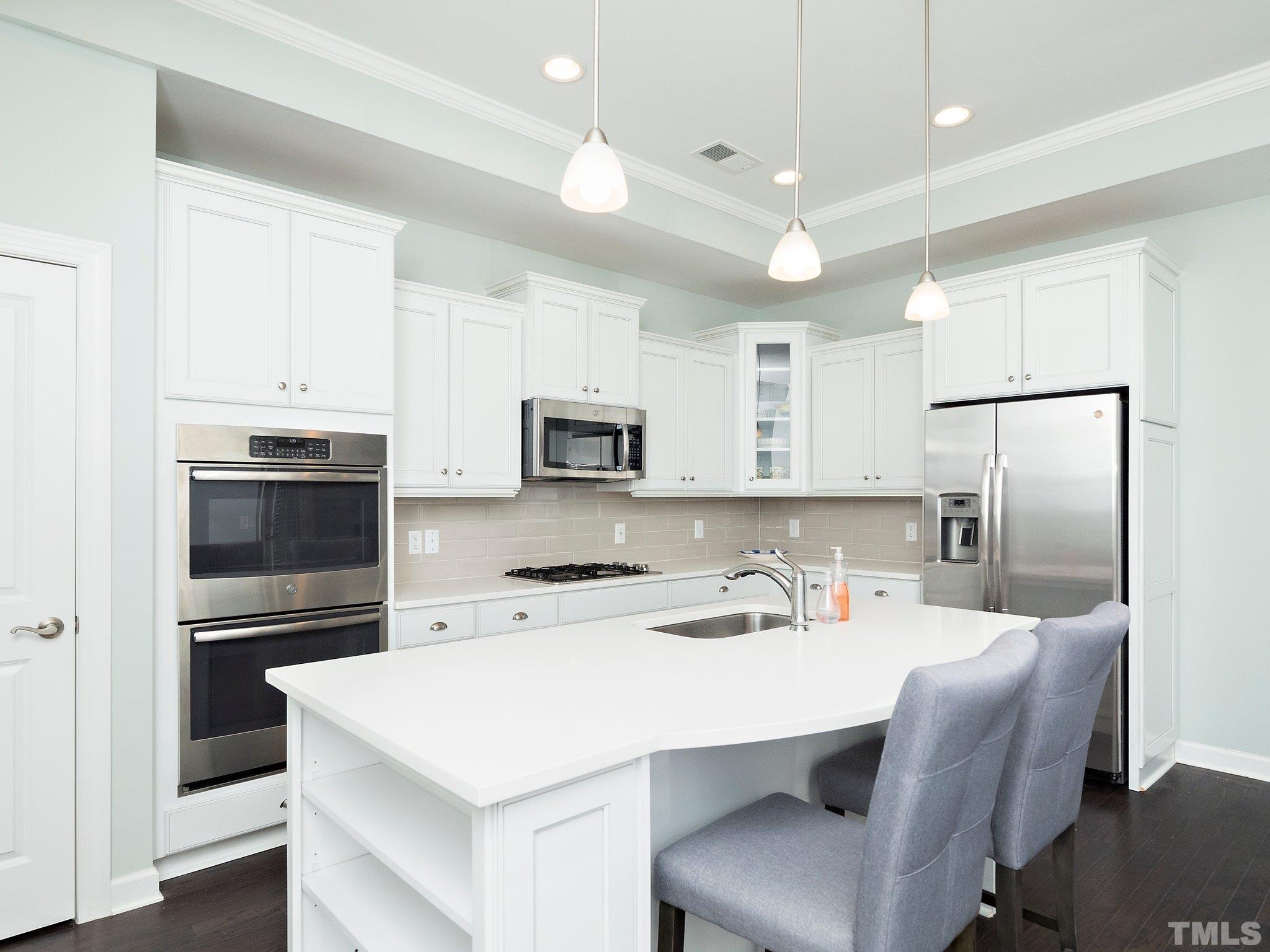 1209 Provision Place Wake Forest, NC 27587 - Photo 9 of 22 a kitchen with stainless steel appliances a refrigerator stove microwave and cabinets