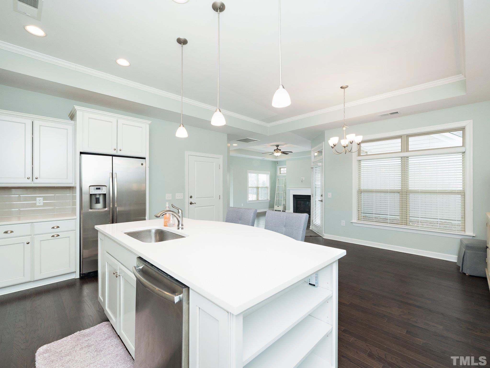 1209 Provision Place Wake Forest, NC 27587 - Photo 10 of 22 a large white kitchen with a stove a sink dishwasher and a refrigerator with wooden floor