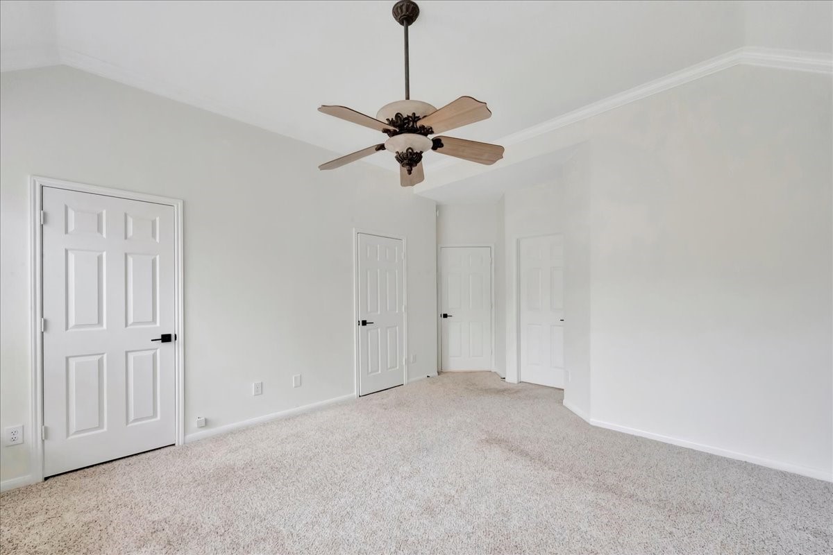 14010 Hazel Ridge Court Houston, TX 77062 - Photo 17 of 38 Downstairs Primary bedroom: doors on the left are to the walk-in closet. Center door is the exit to the rest of the house; ensuite bathroom is the right most door.