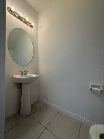 a bathroom with a sink toilet and mirror