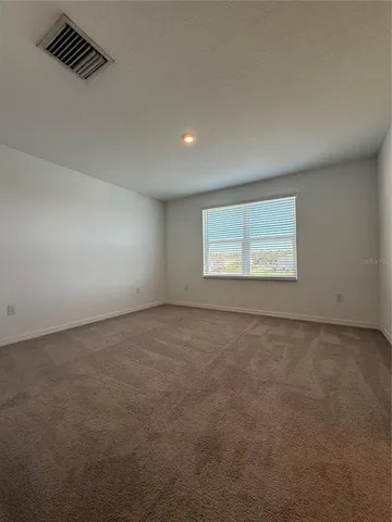 an empty room with a empty space and a window