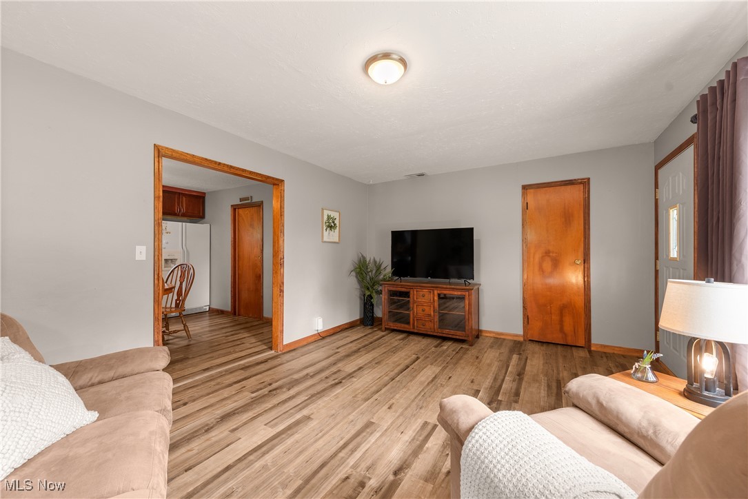 14808 Wheeler Road Lagrange, OH 44050 - Photo 12 of 50 Living room featuring light wood-type flooring and baseboards