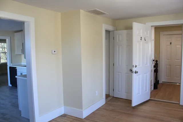 a view of a hallway with wooden floor