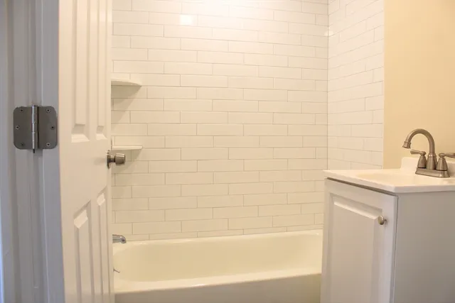 a bathroom with a shower and a sink