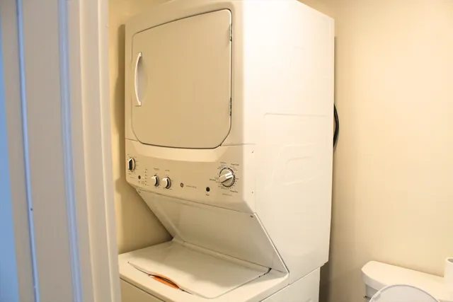 a bathroom with a toilet and a mirror