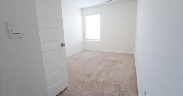 an empty room with closet area