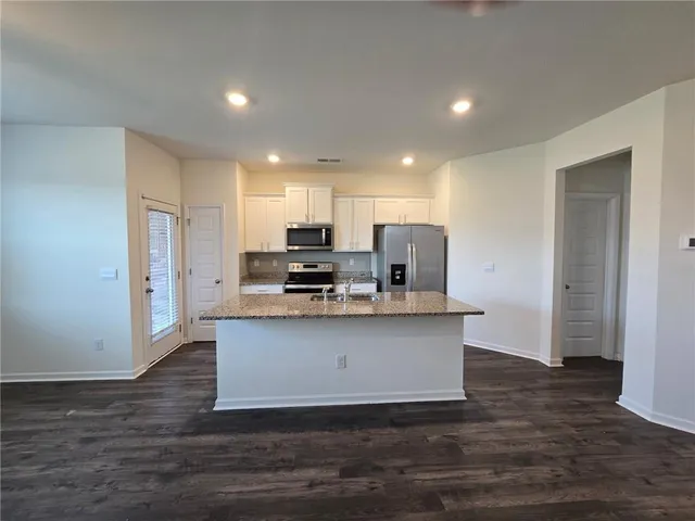a view of kitchen with wooden floor
