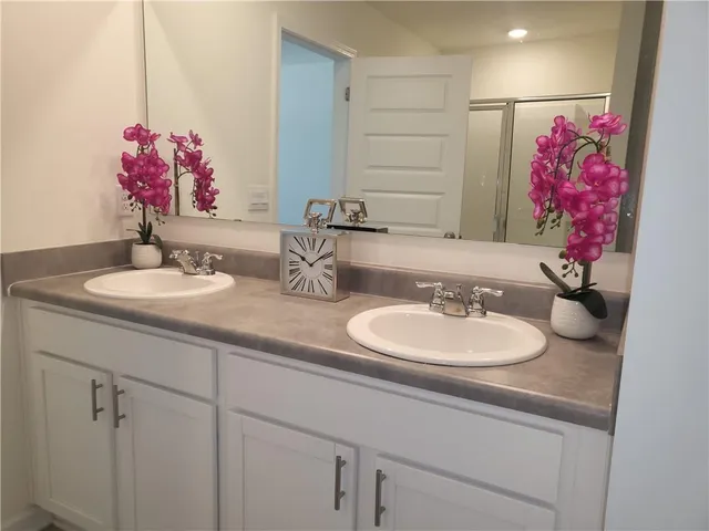 a bathroom with a glass shower door