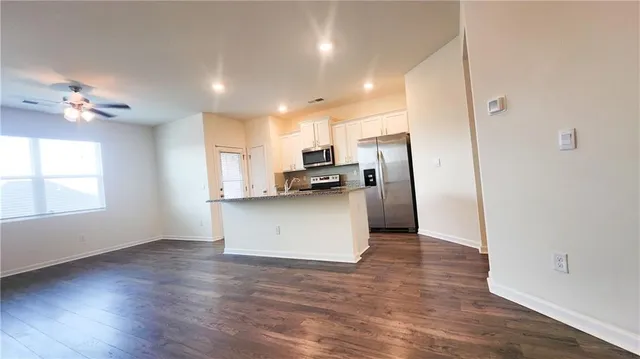 a kitchen with stainless steel appliances a refrigerator sink and stove