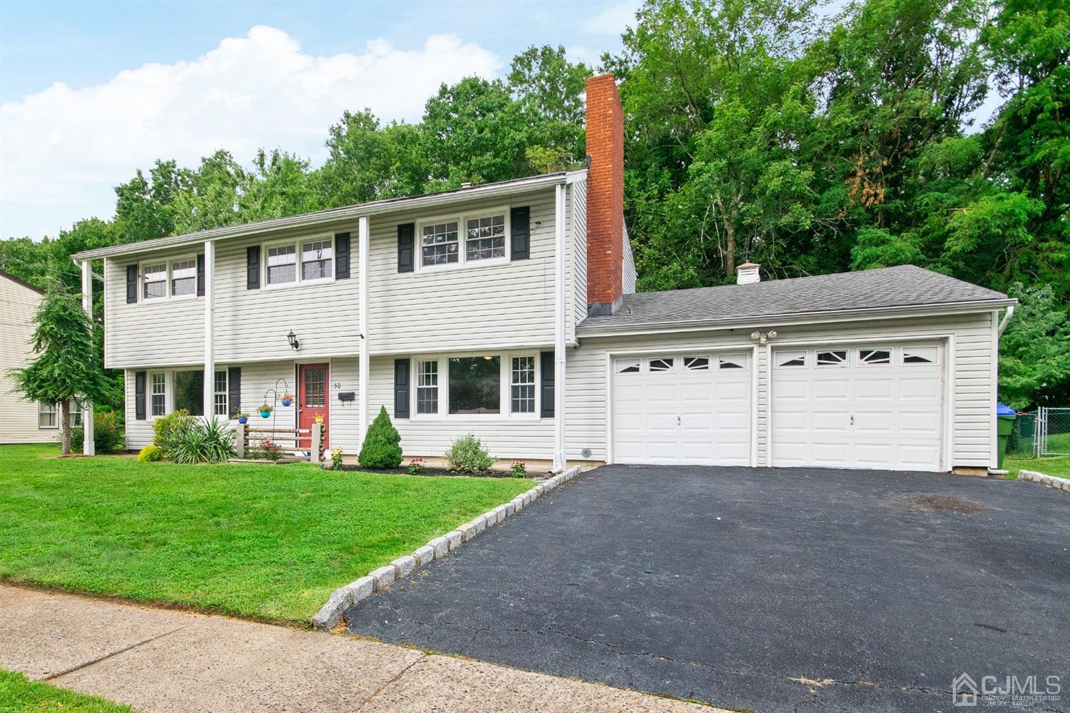 30 Wilk Road Edison, NJ 08837 - Photo 1 of 35 a front view of a house with a garden and yard