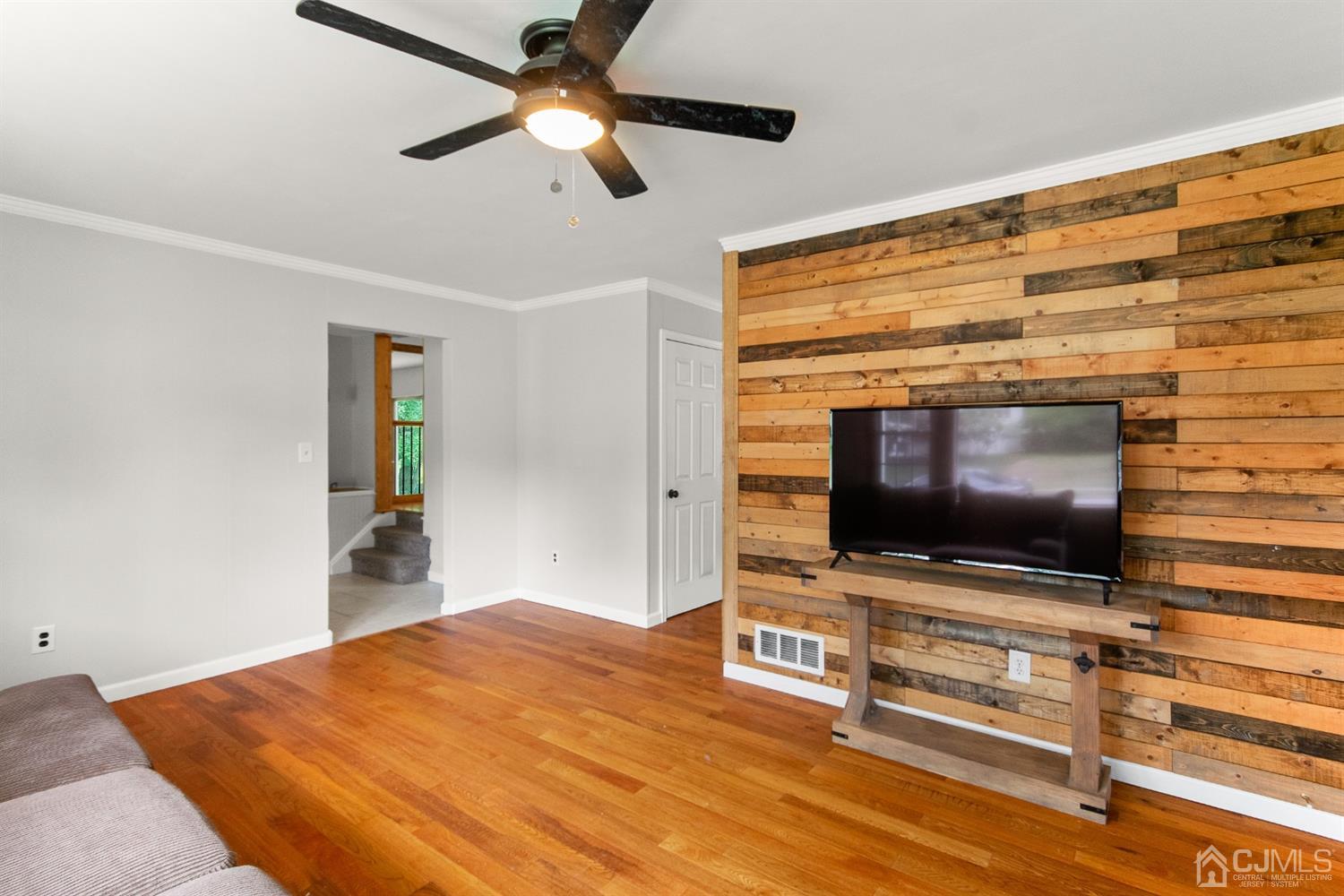 30 Wilk Road Edison, NJ 08837 - Photo 11 of 35 a flat screen tv on a dresser with kitchen view