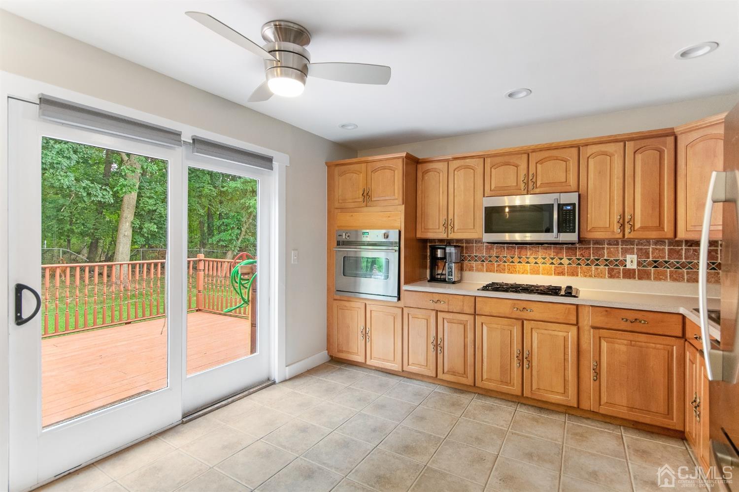 30 Wilk Road Edison, NJ 08837 - Photo 12 of 35 a large kitchen with stainless steel appliances granite countertop a stove top oven a sink dishwasher a dining table and chairs with outer view