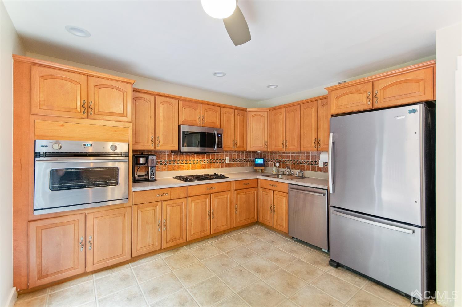 30 Wilk Road Edison, NJ 08837 - Photo 13 of 35 a kitchen with stainless steel appliances granite countertop a refrigerator a stove top oven a sink and dishwasher
