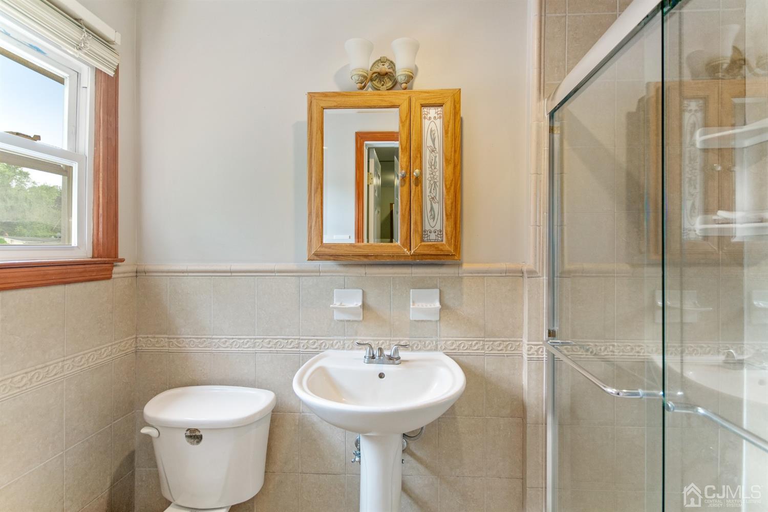 30 Wilk Road Edison, NJ 08837 - Photo 28 of 35 a bathroom with a toilet sink and mirror
