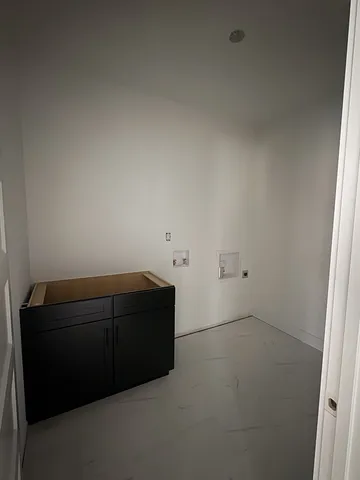 a room with a couch and dryer