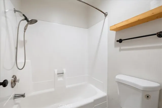 a bathroom with a white bath tub and a shower