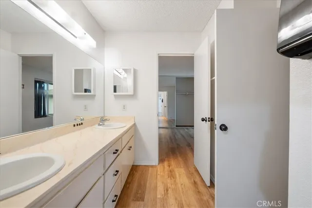 a spacious bathroom with a double vanity sink and mirror
