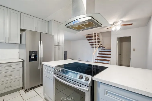 a kitchen with a stove cabinets and stainless steel appliances