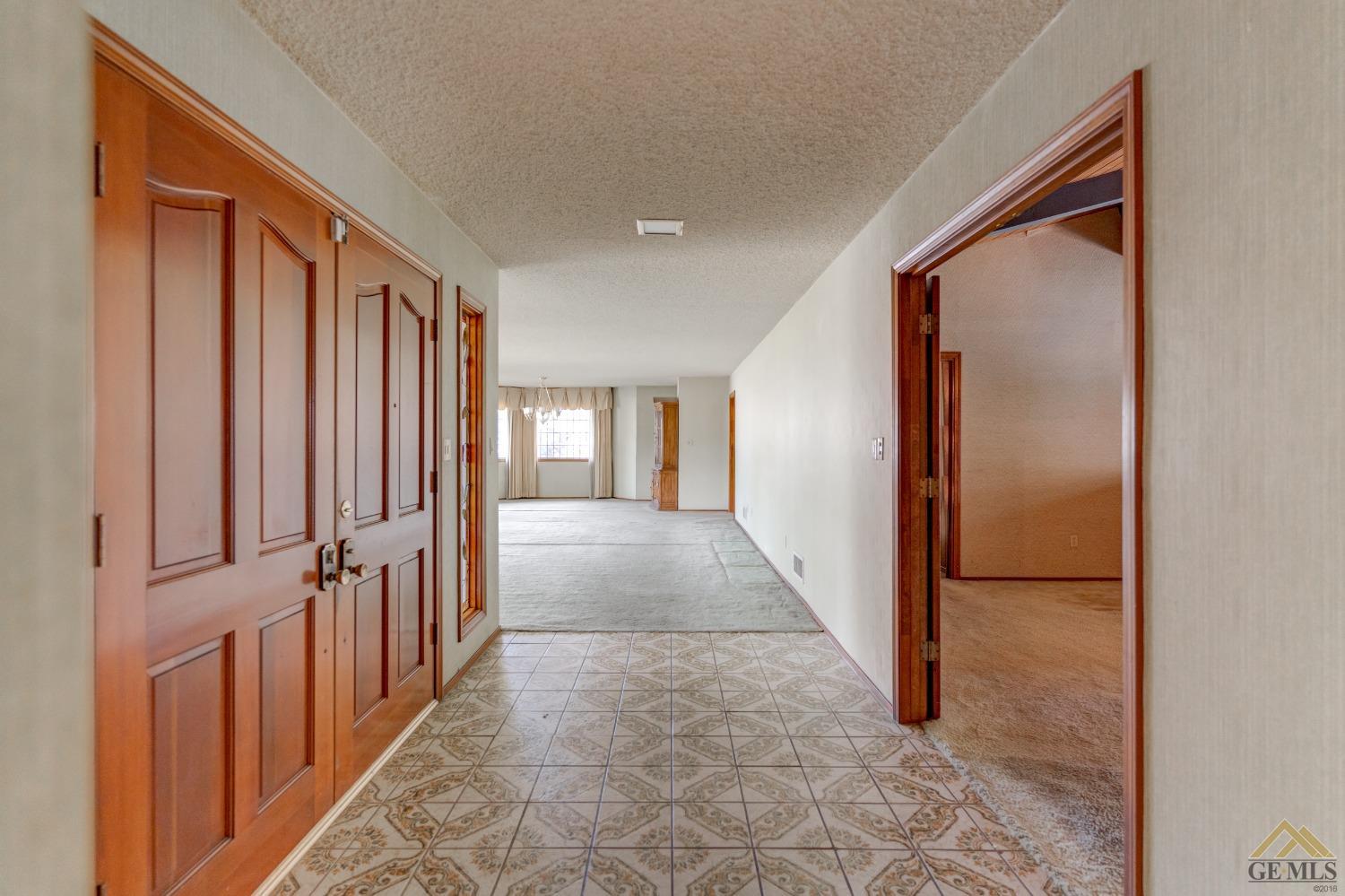 Undisclosed Address Bakersfield, CA 93309 - Photo 16 of 38 a view of a hallway with wooden floor and staircase