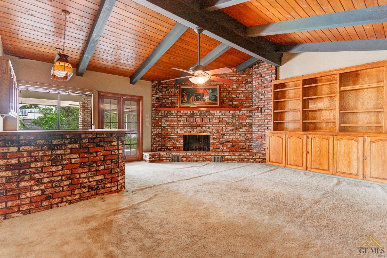Undisclosed Address Bakersfield, CA 93309 - Photo 17 of 38 a view of an empty room with a fireplace and a window