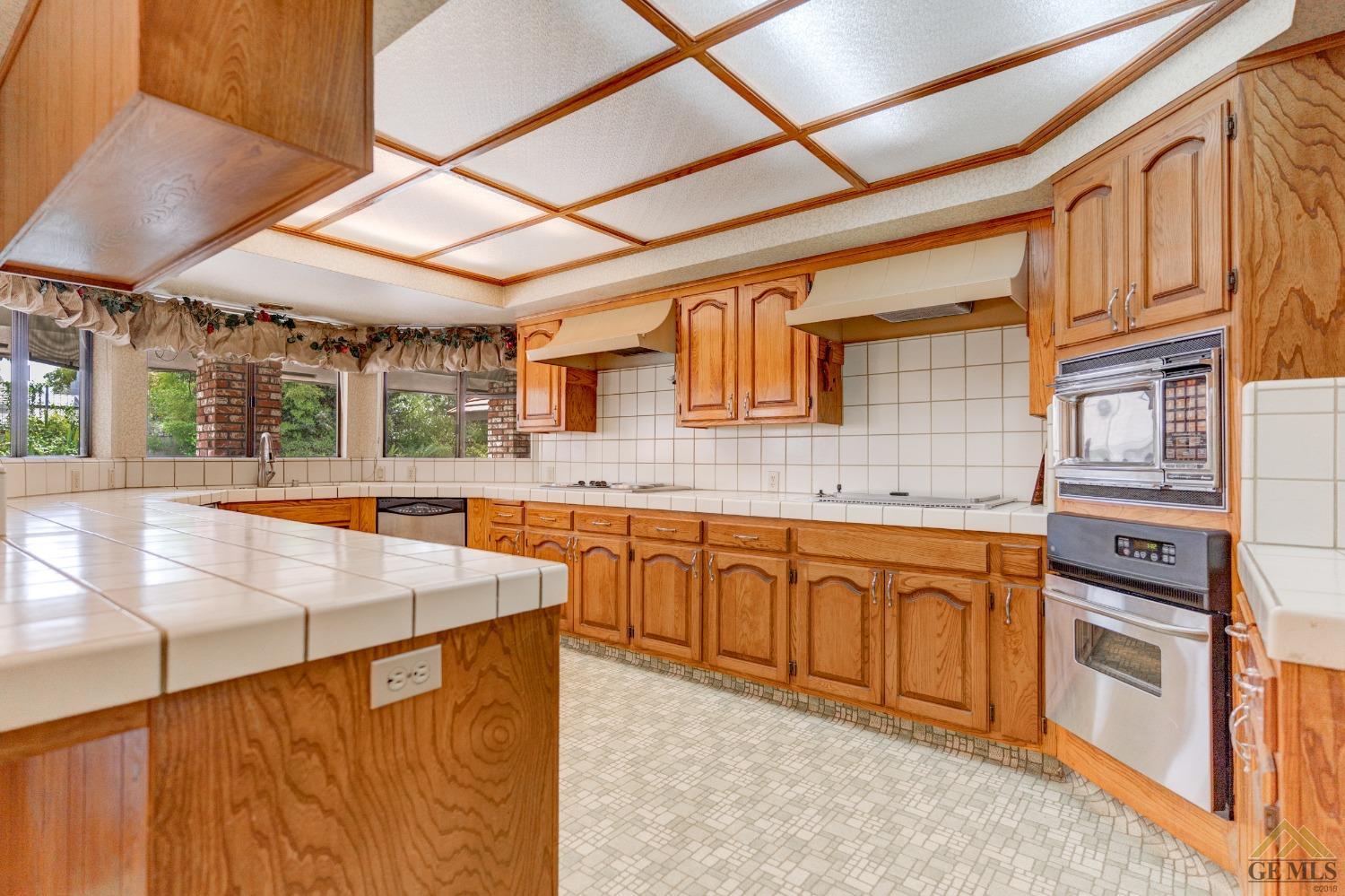 Undisclosed Address Bakersfield, CA 93309 - Photo 20 of 38 a view of a kitchen with stainless steel appliances granite countertop a sink and cabinets