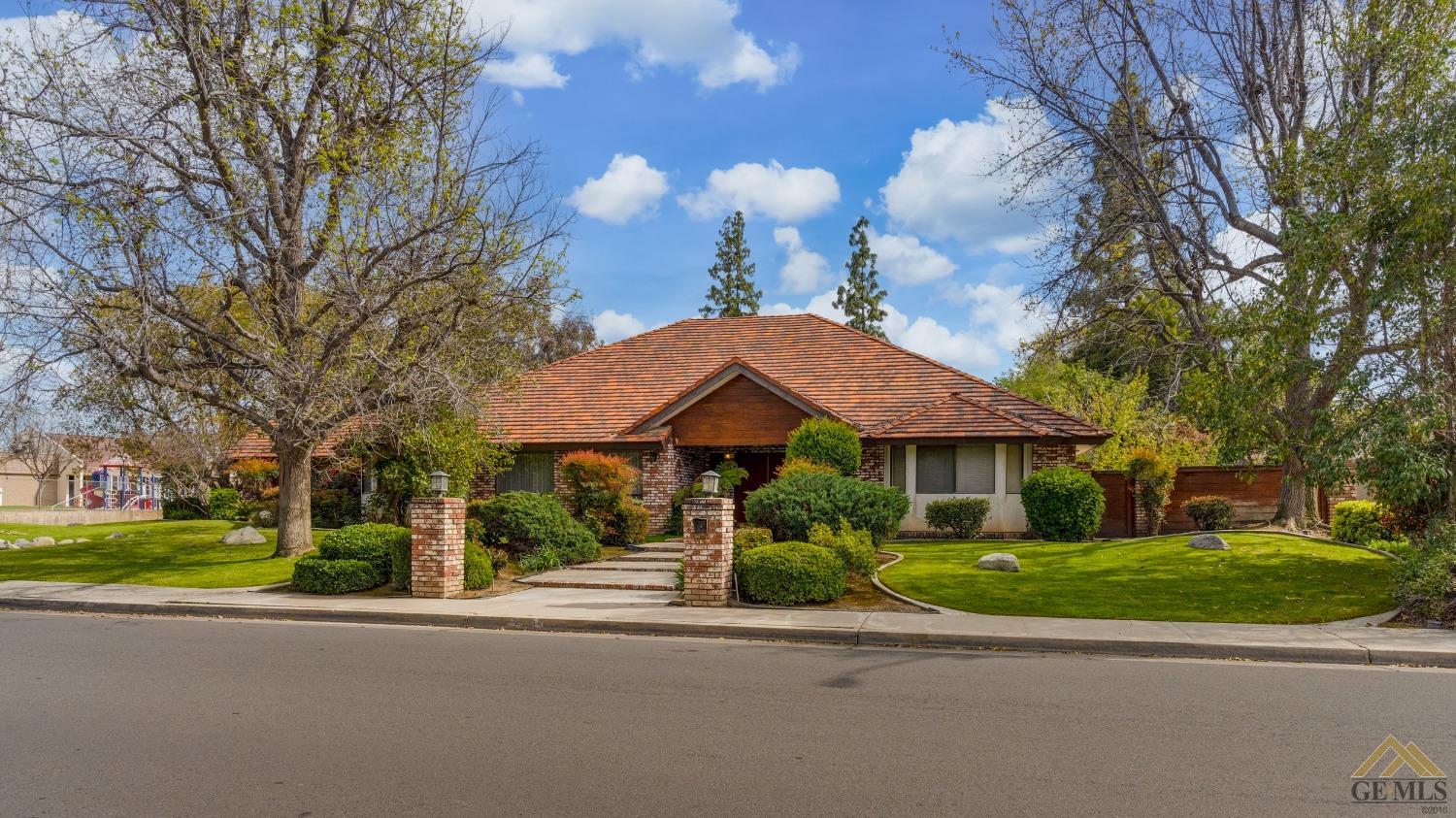 Undisclosed Address Bakersfield, CA 93309 - Photo 2 of 38 a view of a house with a garden and pathway