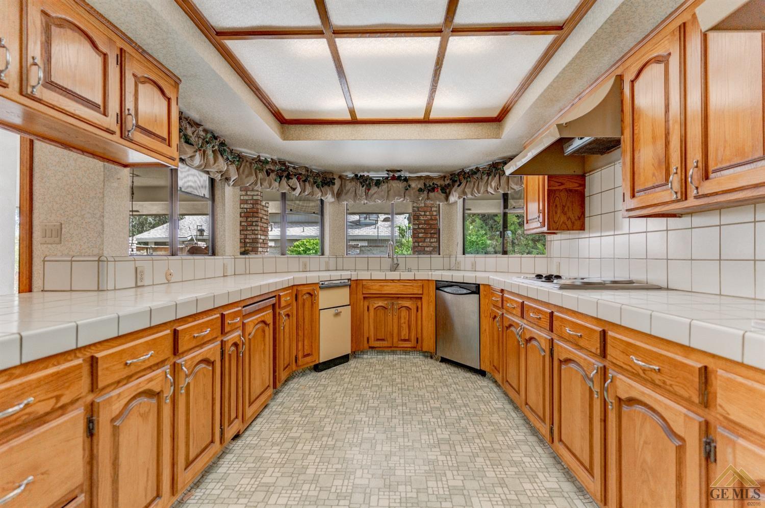 Undisclosed Address Bakersfield, CA 93309 - Photo 21 of 38 a large kitchen with stainless steel appliances kitchen island granite countertop a large kitchen counter top a stove and a sink