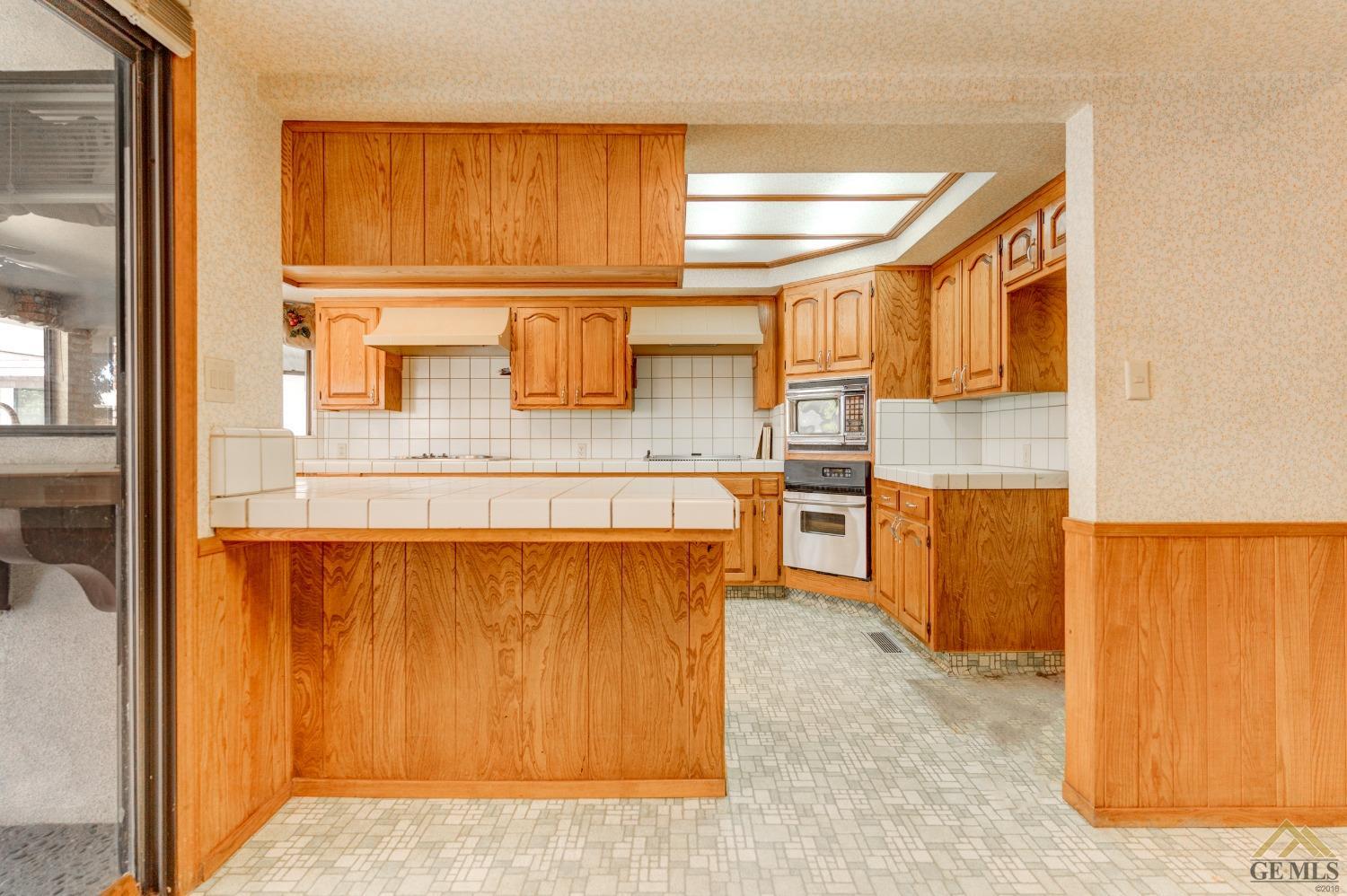 Undisclosed Address Bakersfield, CA 93309 - Photo 22 of 38 a kitchen with stainless steel appliances granite countertop a sink and cabinets