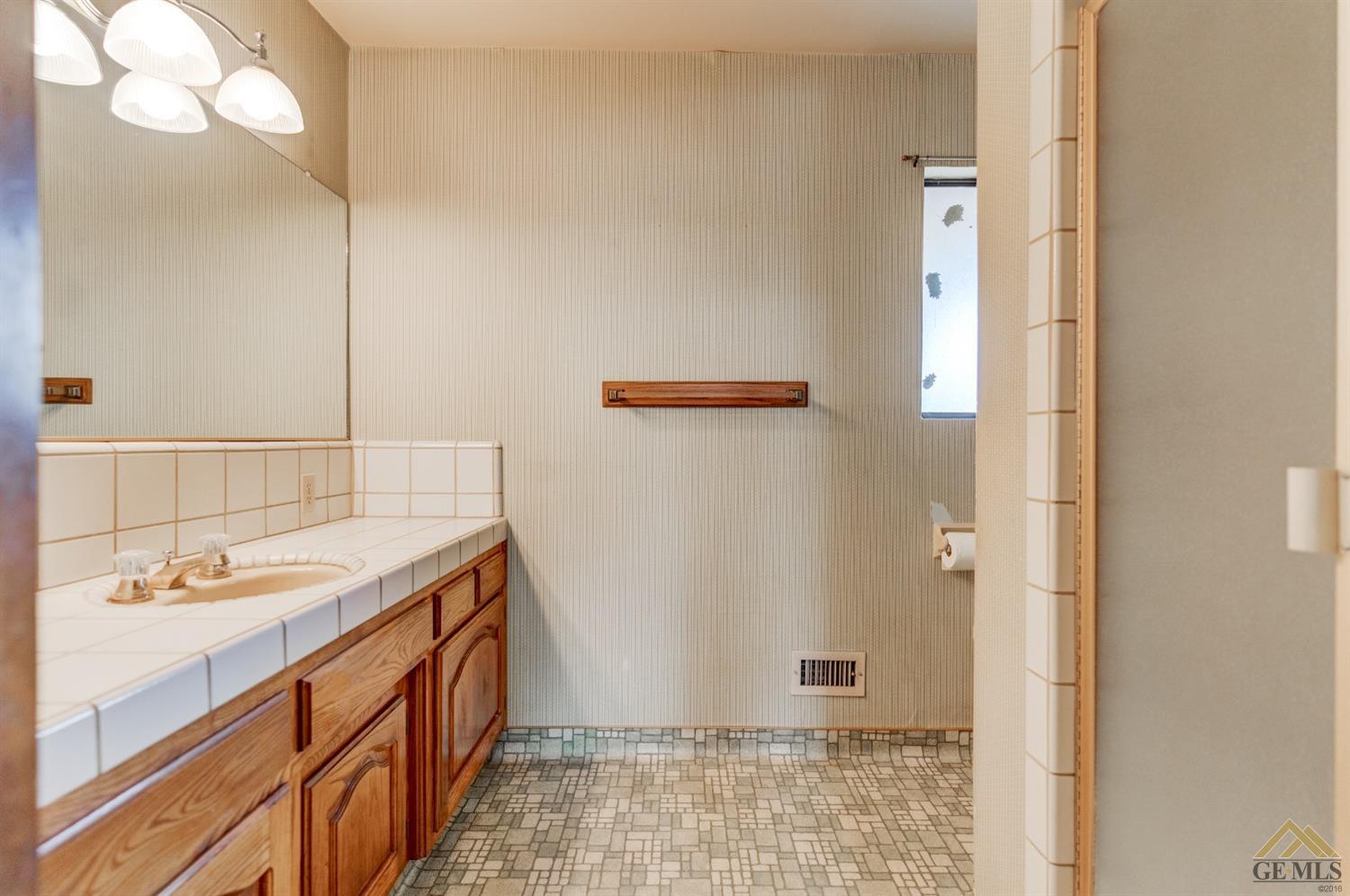 Undisclosed Address Bakersfield, CA 93309 - Photo 26 of 38 a bathroom with a sink and a mirror