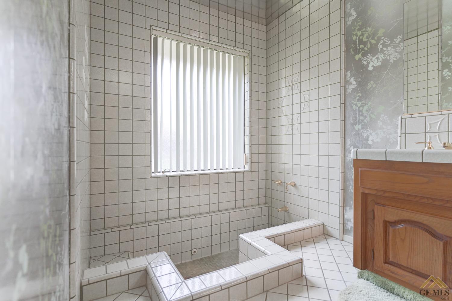 Undisclosed Address Bakersfield, CA 93309 - Photo 28 of 38 a bathroom with a sink a toilet and mirror