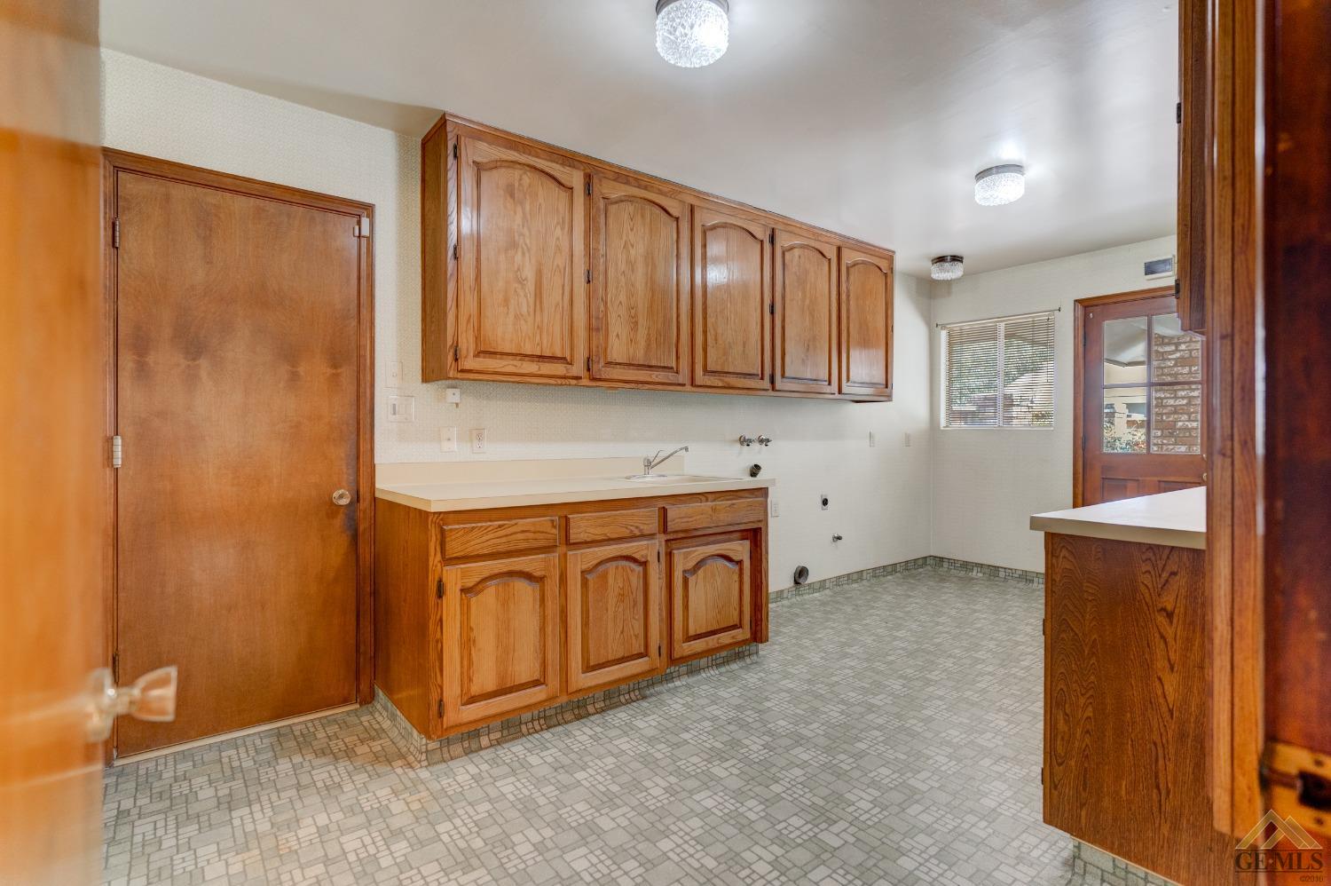 Undisclosed Address Bakersfield, CA 93309 - Photo 30 of 38 a kitchen with stainless steel appliances granite countertop a refrigerator a stove and a sink with wooden cabinets