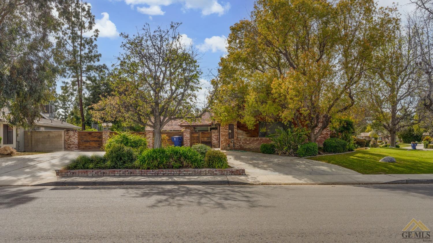 Undisclosed Address Bakersfield, CA 93309 - Photo 4 of 38 front view of a house next to a road