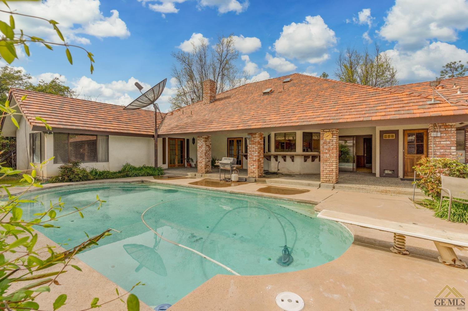 Undisclosed Address Bakersfield, CA 93309 - Photo 6 of 38 a view of a white house with swimming pool table and chairs