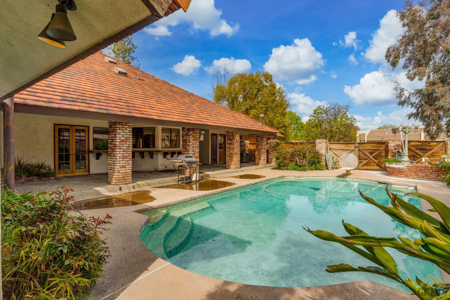 Undisclosed Address Bakersfield, CA 93309 - Photo 10 of 38 a view of a house with swimming pool patio and garden