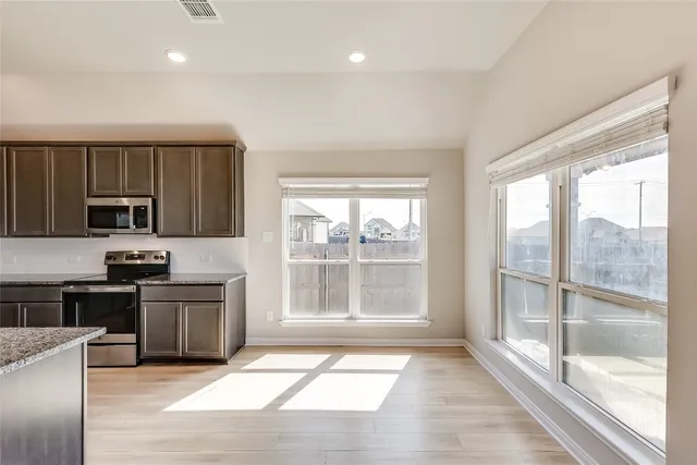 a view of a kitchen with a sink and cabinets