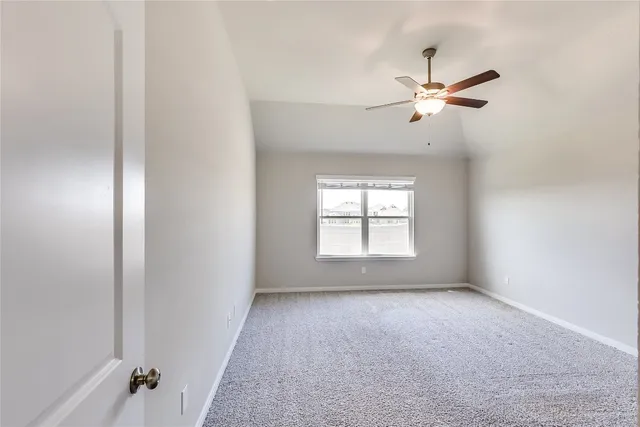 a view of room with a ceiling fan and window