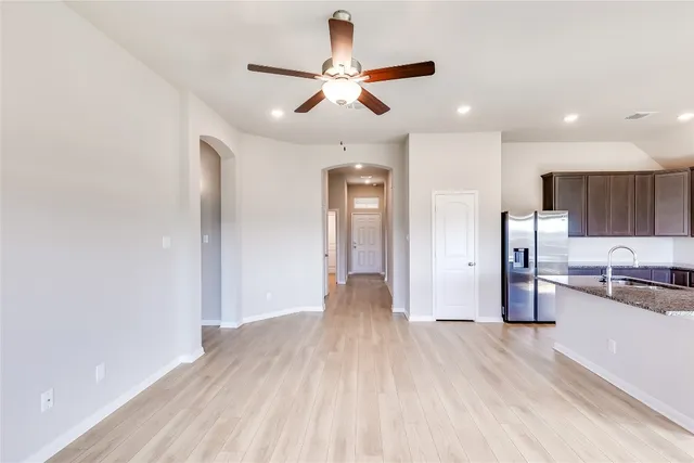 a view of a kitchen with a sink and wooden floor