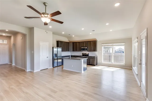 a view of kitchen with cabinets and wooden floor