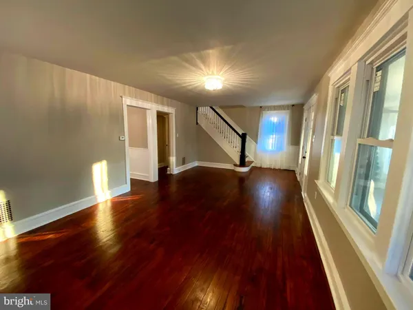 a view of a hallway with wooden floor and a fireplace