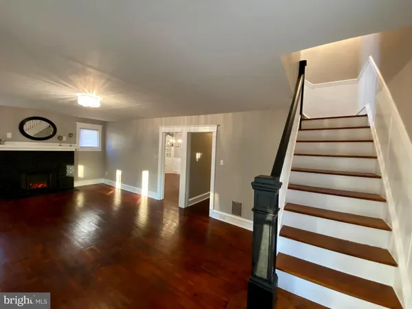 a view of a room with wooden floor