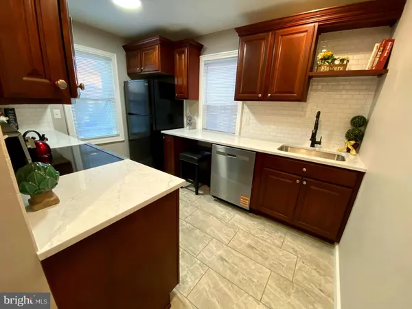 a kitchen with stainless steel appliances granite countertop a sink stove and a refrigerator