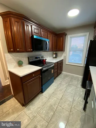 a kitchen with a sink refrigerator and cabinets