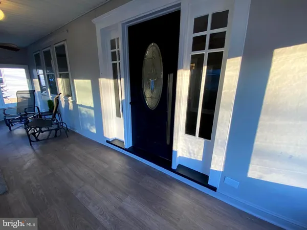 a view of an entryway with wooden floor