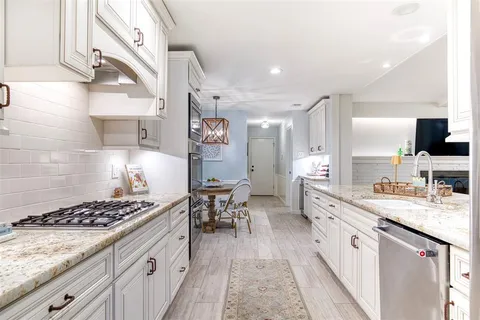 a kitchen with a stove and cabinets