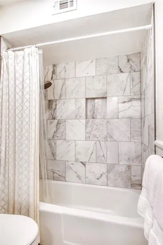 a bathroom with a bathtub and shower